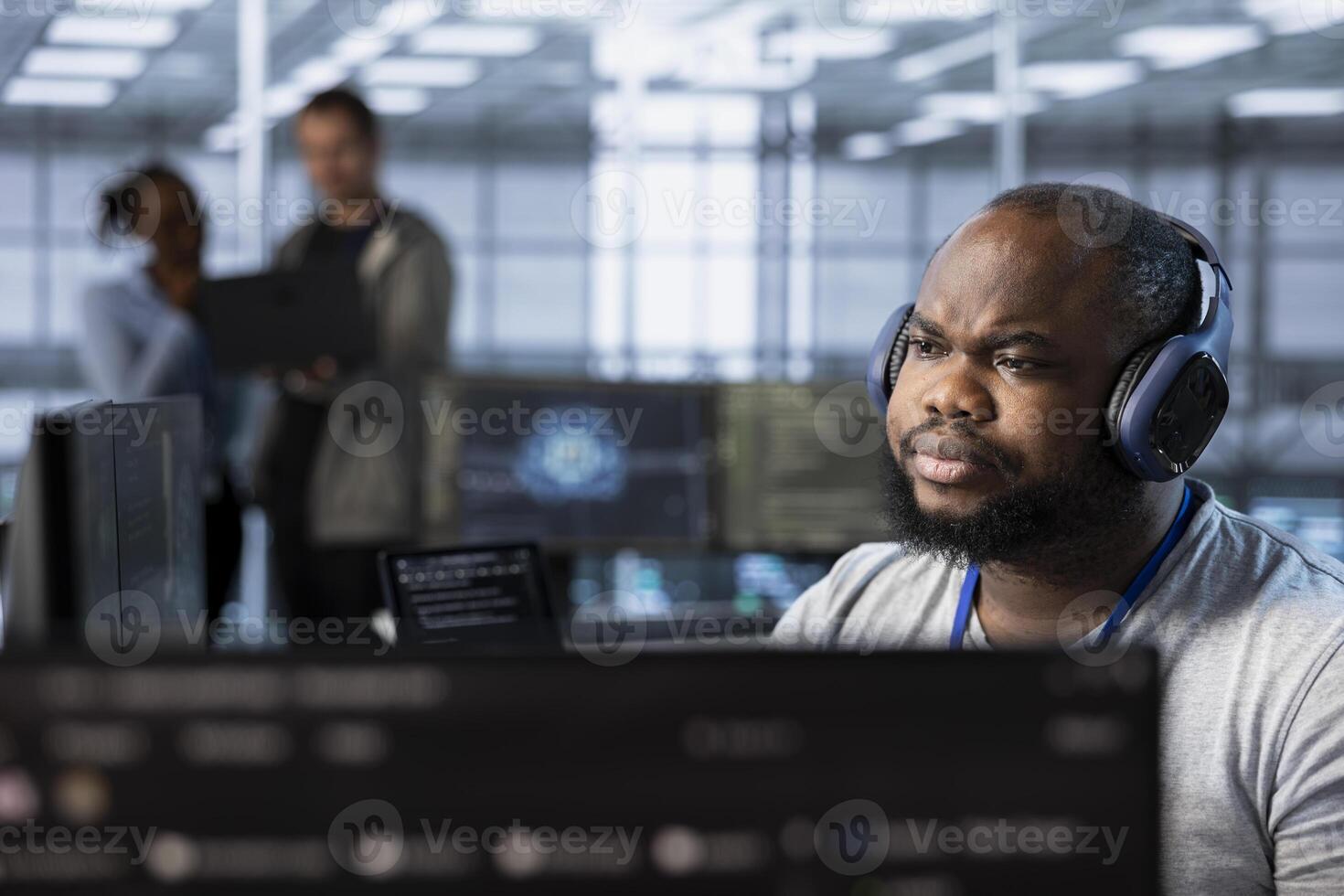 Admin in server hub listening music and ensuring compliance with industry standards and regulatory requirements. Data center worker wearing headphones enjoying songs and conducting security audits photo