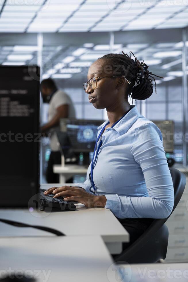 Engineer in data center managing and optimizing large scale IT infrastructure, using network management skills. Server room worker upgrading equipment, reducing operational costs photo