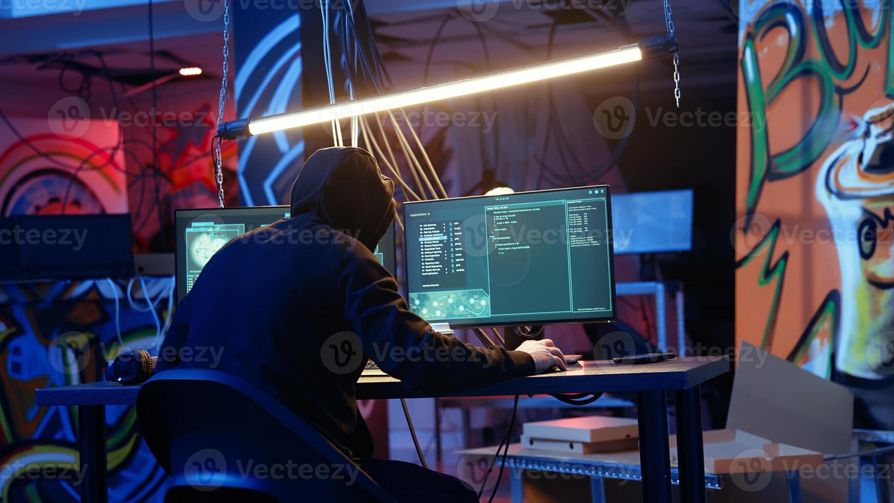 Skilled hacker deploying malware on unaware victims computers, stealing sensitive and private information, selling on darknet to highest bidder, looking at computer screen in hideout, camera A photo