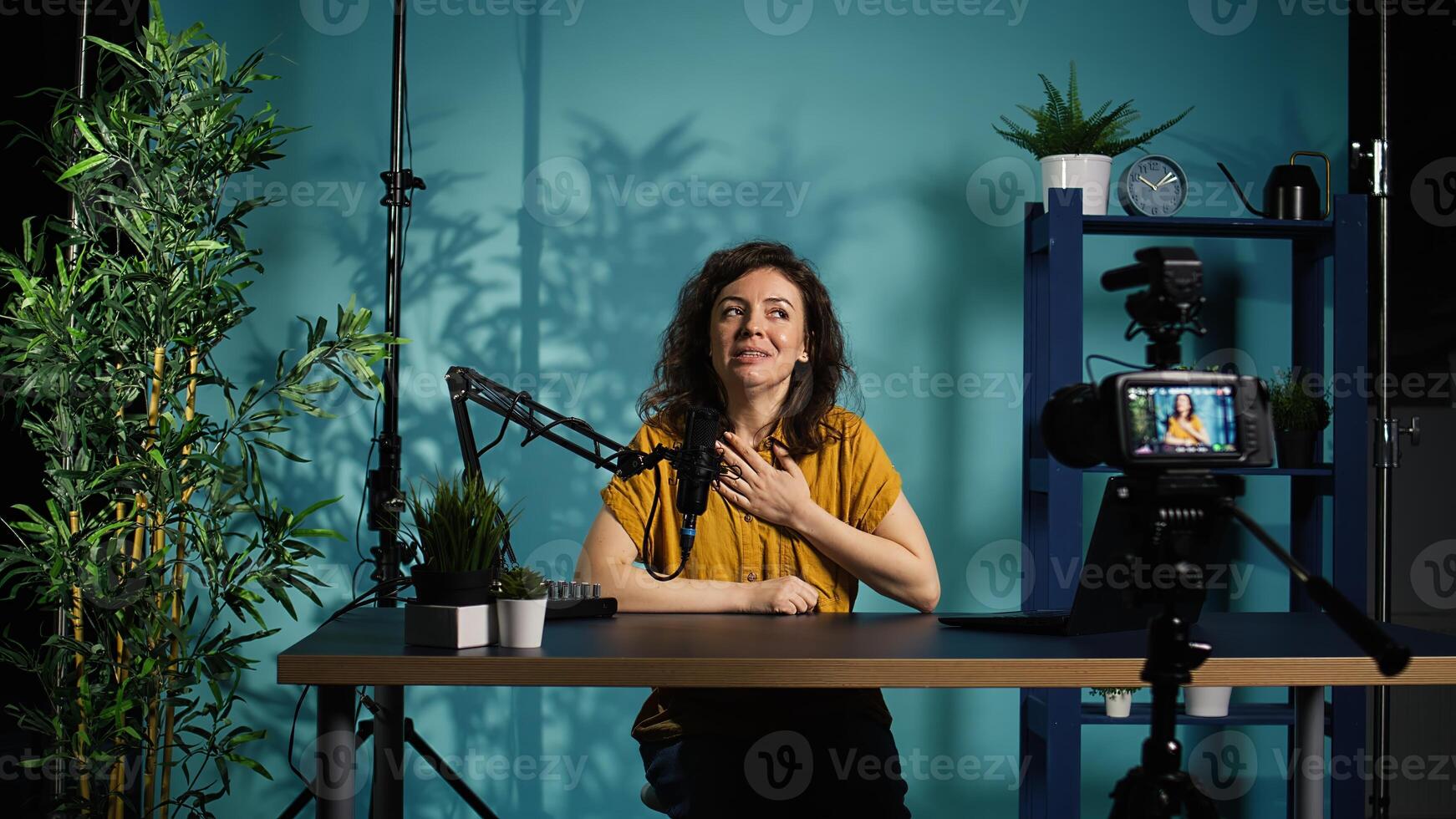 Professional camera used for recording woman chatting with online audience, filming in home studio. Media star discussing with fans during live broadcast stream recorded with advanced gear, camera B photo