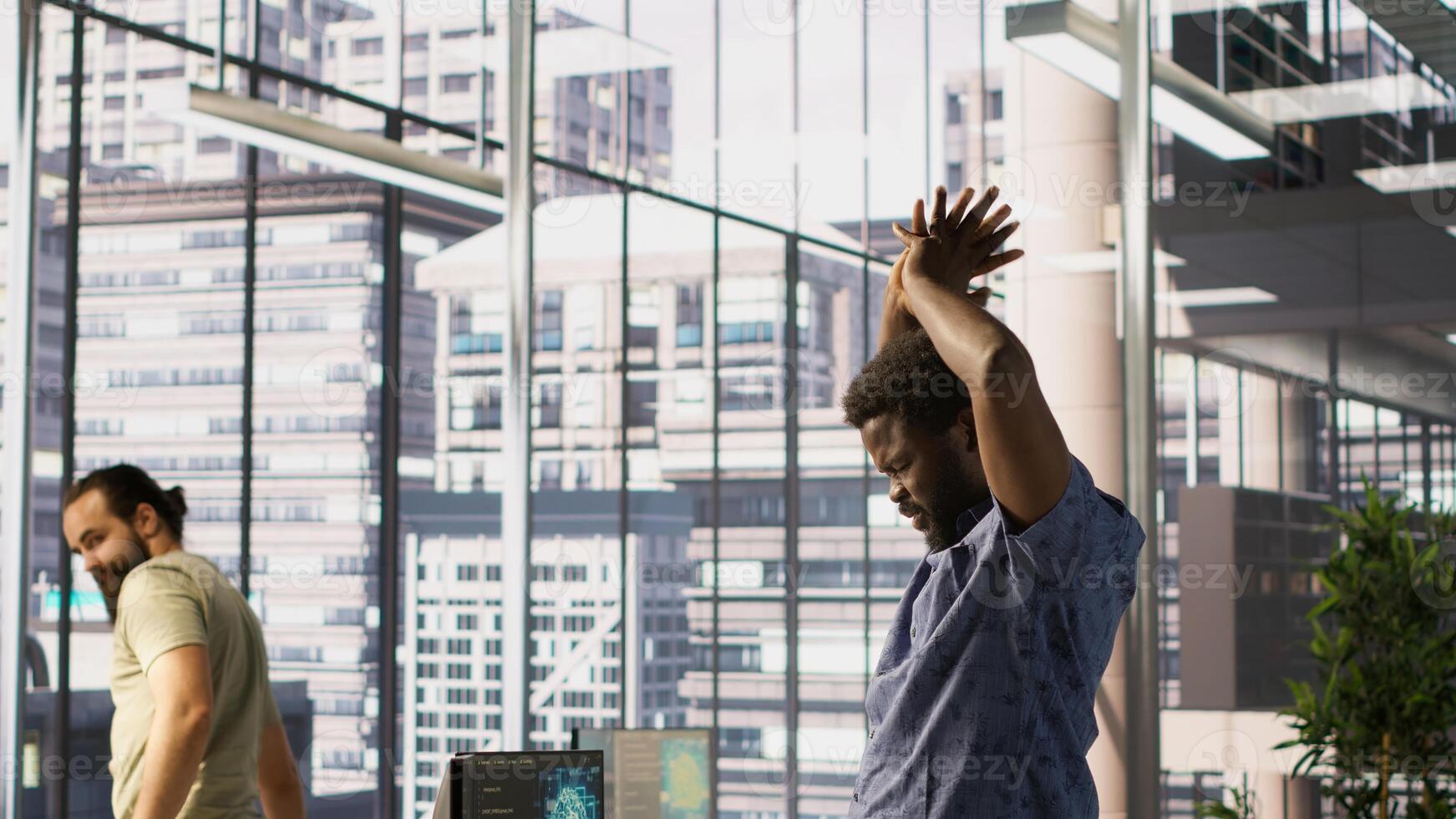 Tired admin stretches limbs while using PC for artificial intelligence computing simulating human brain. Fatigued worker relaxing back, feeling strained after working with AI neural networks, camera A photo