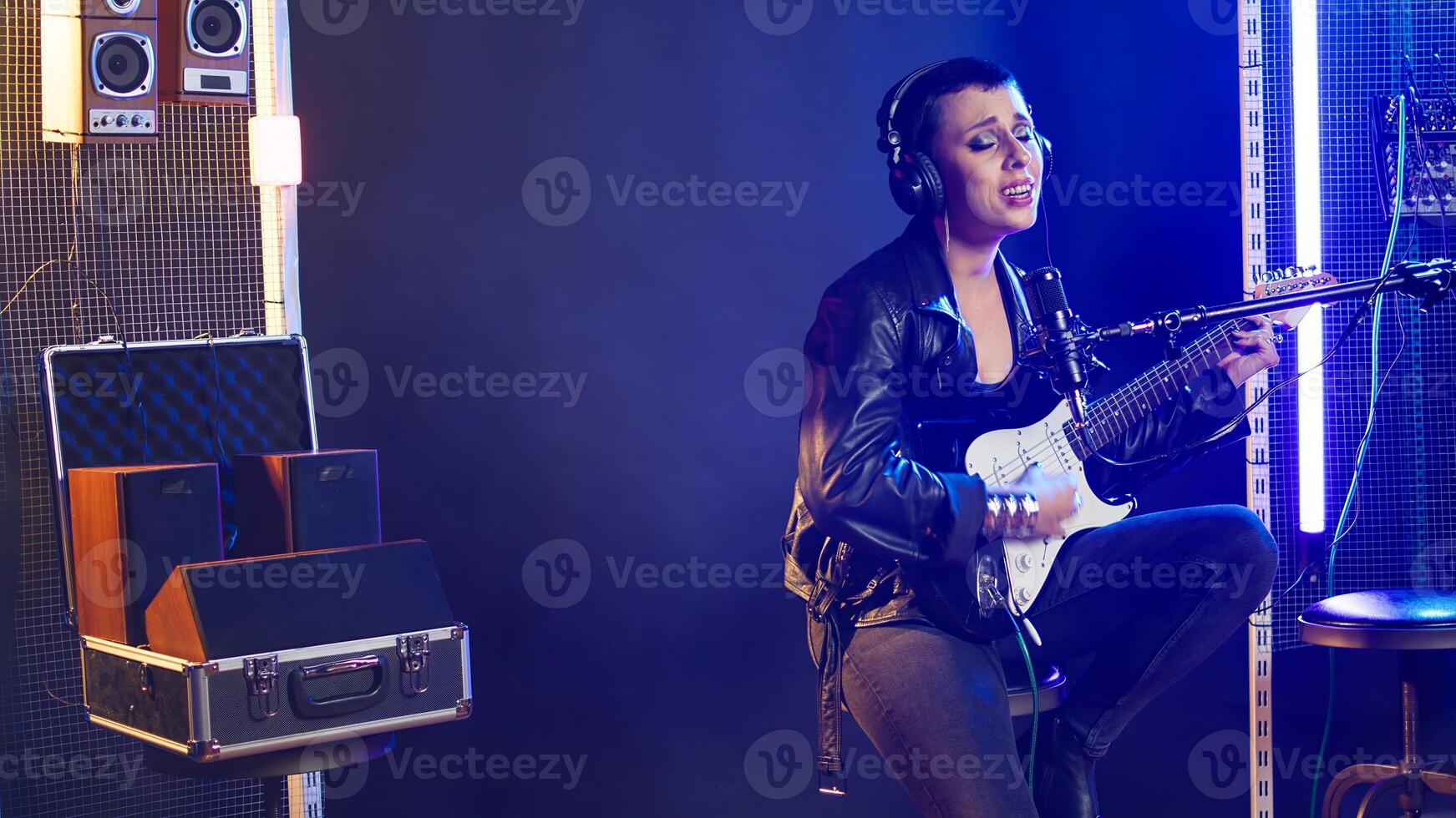 Rock star iconic artist performing live in a dark urban nightclub, showing her powerful and melodic voice. Singer with a grunge edgy style and fierce energy singing a thrash metal song. Camera A. photo