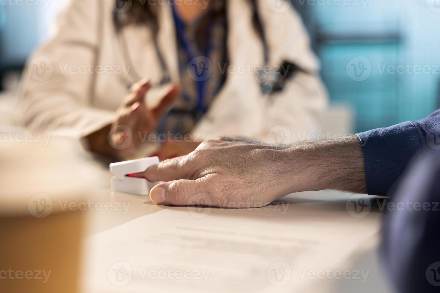 Health specialist takes the oxygen saturation measurement and checking vital signs during a routine check up with her old patient. Medic using an oximeter for accurate readings. Close up. photo