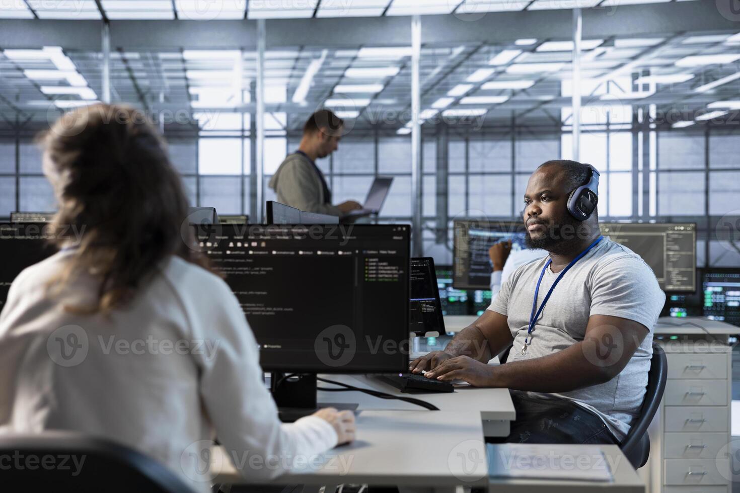 Engineer in data center coordinating deployment of server architecture, improving data processing speed in client workload capacity. Server room expert configuring and testing hardware photo