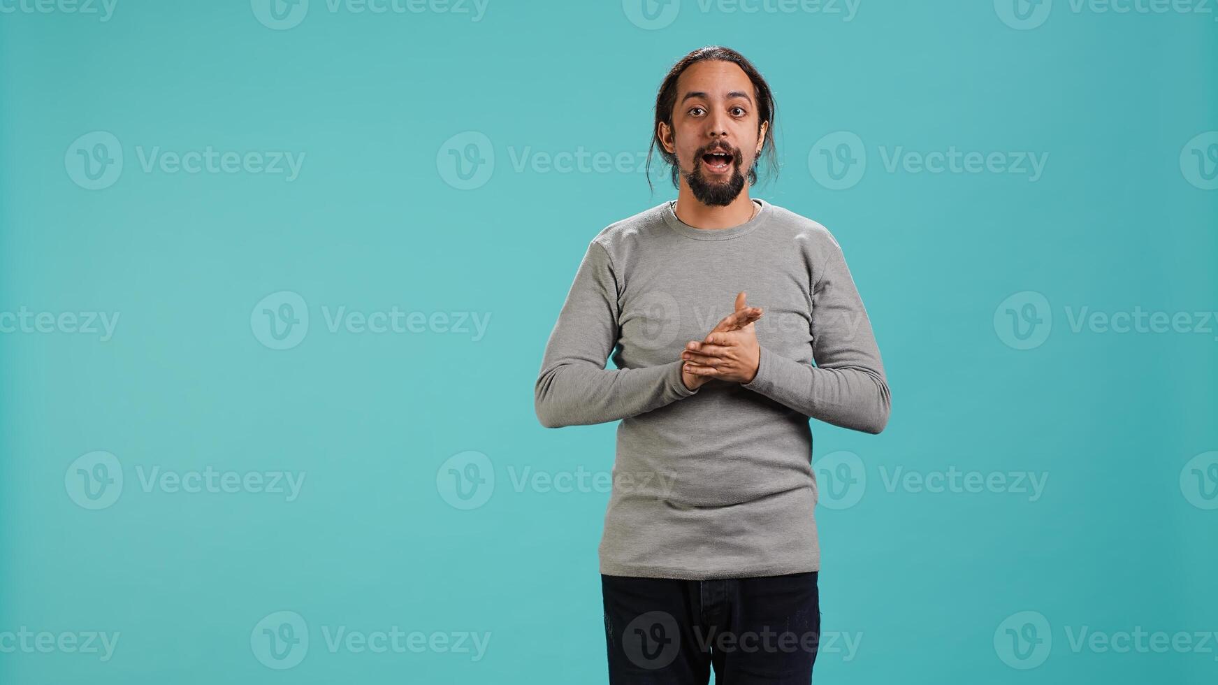 Disappointed man admonishing friend over debacle, isolated over blue studio background. Upset person in disagreement with mate, pointing finger and lecturing him, camera A photo