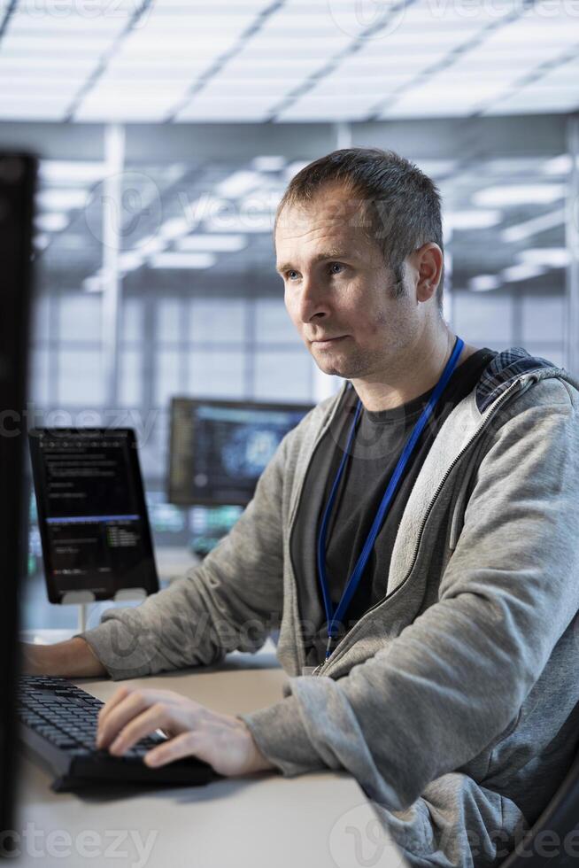 Data center admin developing disaster recovery plans ensuring minimal downtime. Server hub IT expert utilizing data analytics to monitor performance and predict future infrastructure needs photo