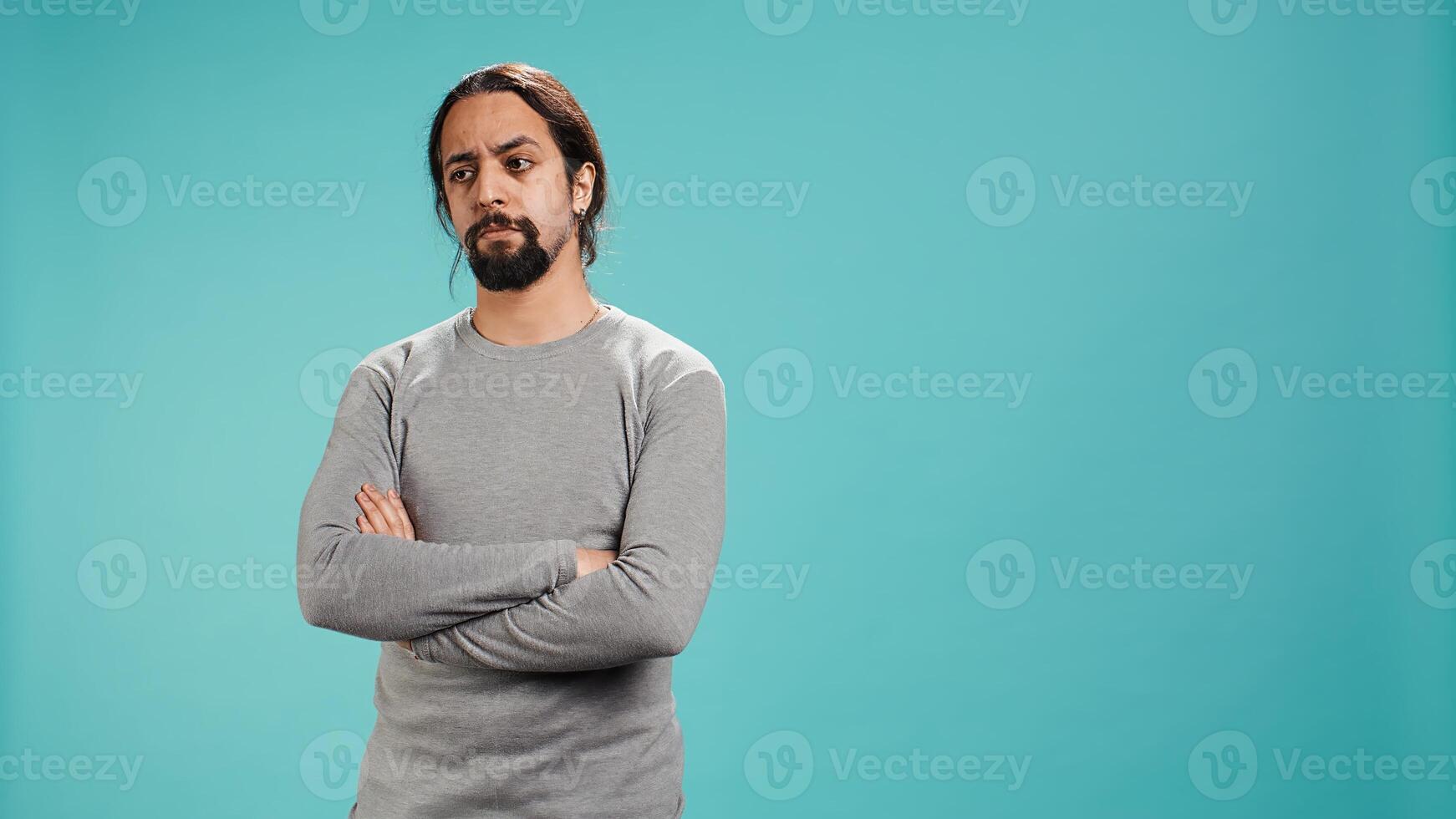Grumpy man crossing arms, feeling upset by events, isolated over studio background. Portrait of stressed moody person shaking head, left speechless by troubling news, camera B photo