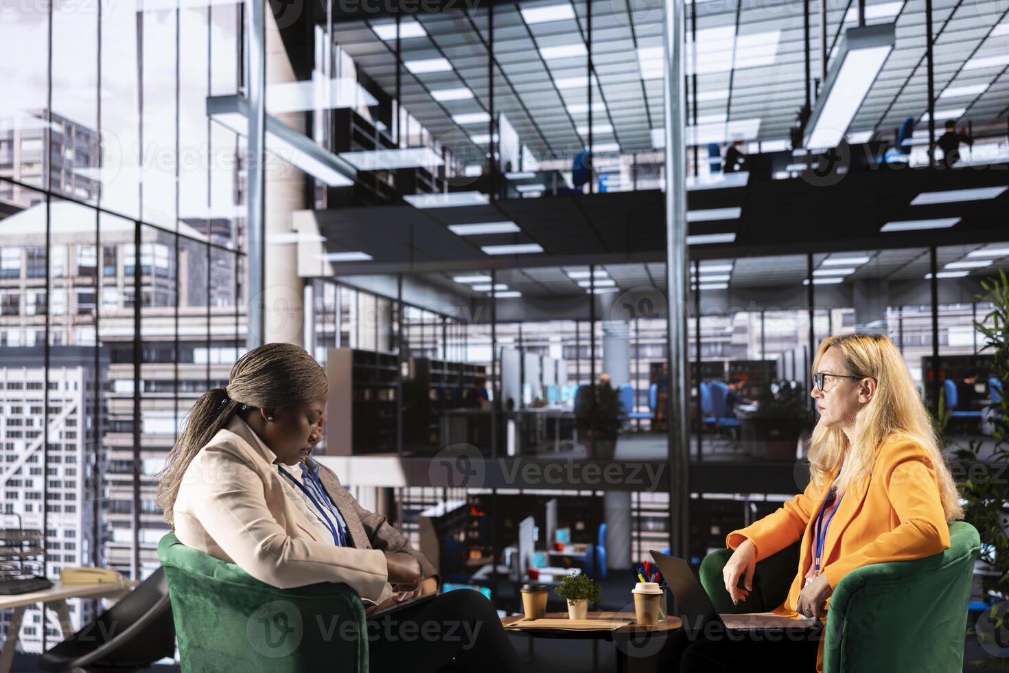 Ambitious women executives collaborating in a diverse work environment, discussing strategies for corporate growth and equal rights. Empowerment and resilience lead the way to a success story. photo
