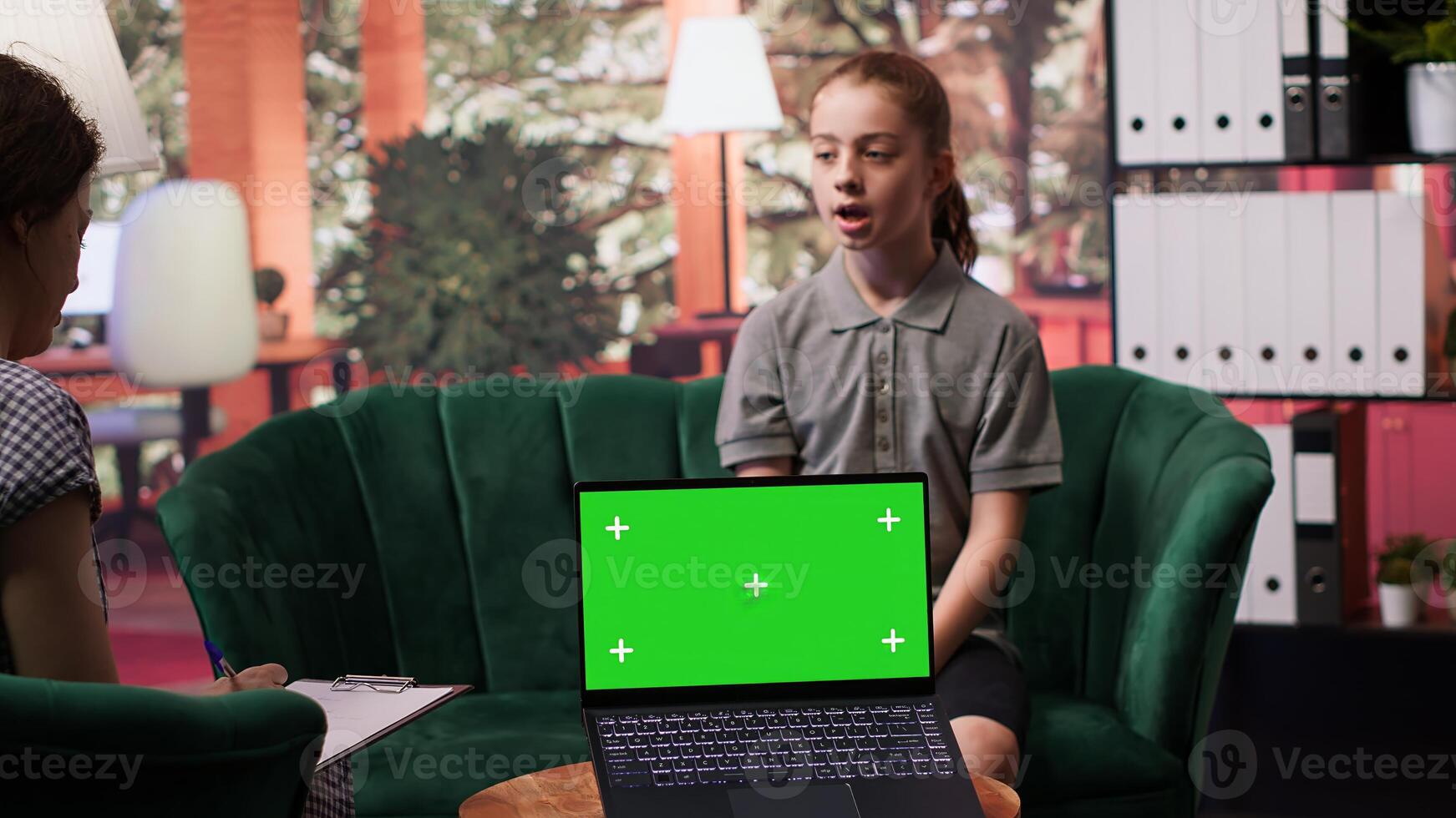 Teenager undergoing therapy for depression next to isolated chroma key screen, asking advice to boost self esteem. Psychologist expert guiding her to overcome her internal frustration. Camera A. photo