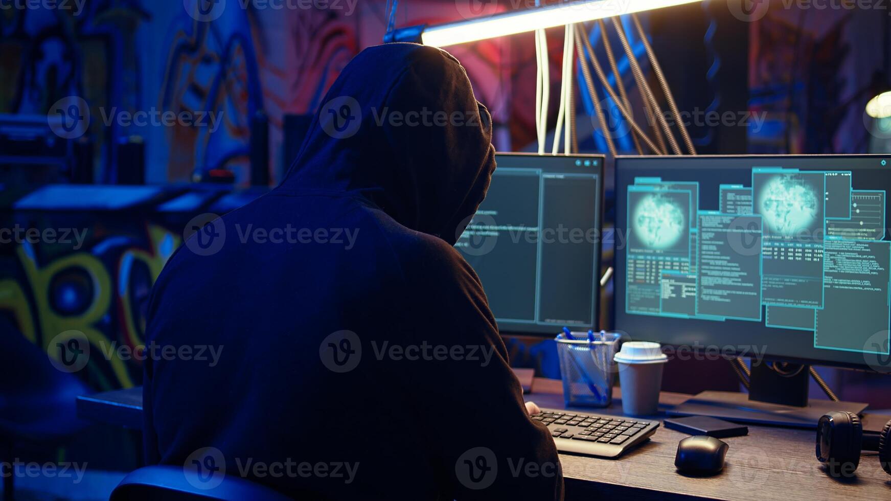 Evil cybercriminal in hidden base targeting vulnerable unpatched connections, getting past computer defenses and stealing data, dolly in shot. Hacker destroying firewalls and infecting computers photo