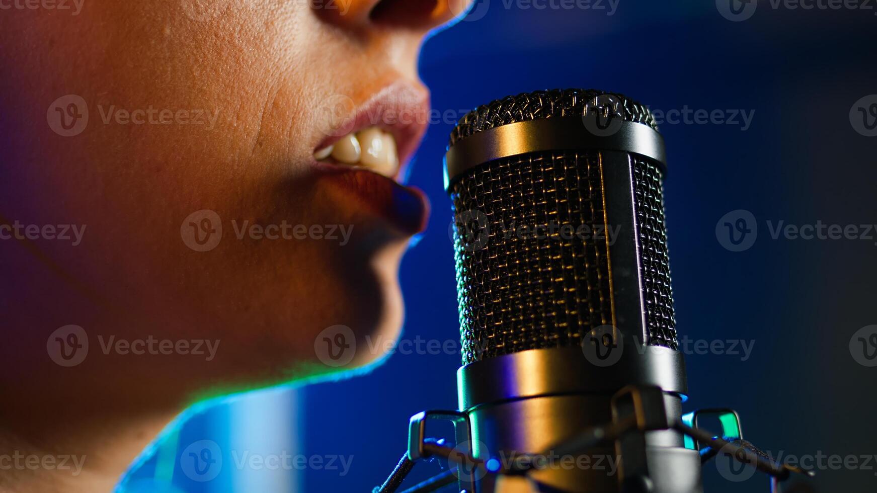 Punk rock artist singing a heavy metal alternative song on microphone, creating an iconic fierce wild performance at nightclub. Superstar performer with a cool style. Close up. Camera A. photo