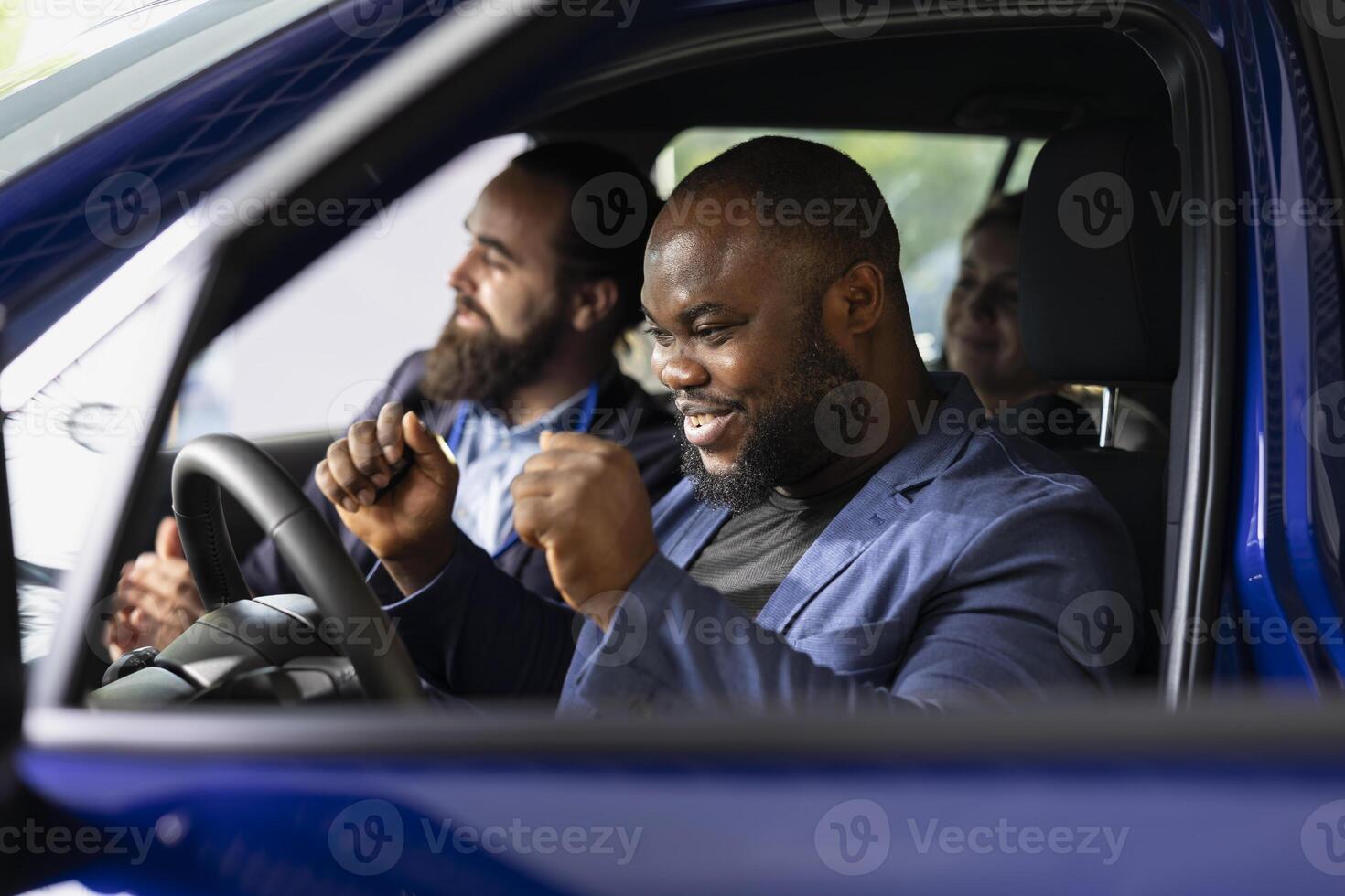 Happy customer agreeing terms with car showroom salesman after finishing test drive and being satisfied. Clients reaching agreement with agent in dealership after driving vehicle photo