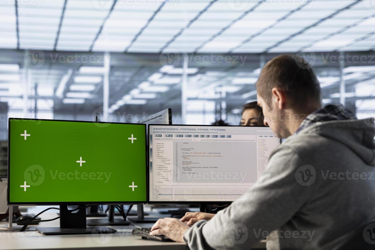 Engineer in server farm using green screen PC to repair equipment storing datasets. IT professional using mockup computer to do debugging on rigs doing computational operations photo