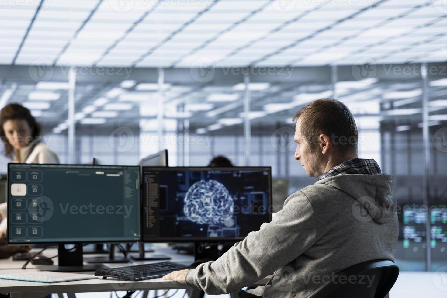 Computer scientist in data center coding AI LLM chatbo answering user prompts using predictive technology. Server room employee building large language model program using artificial intelligence photo