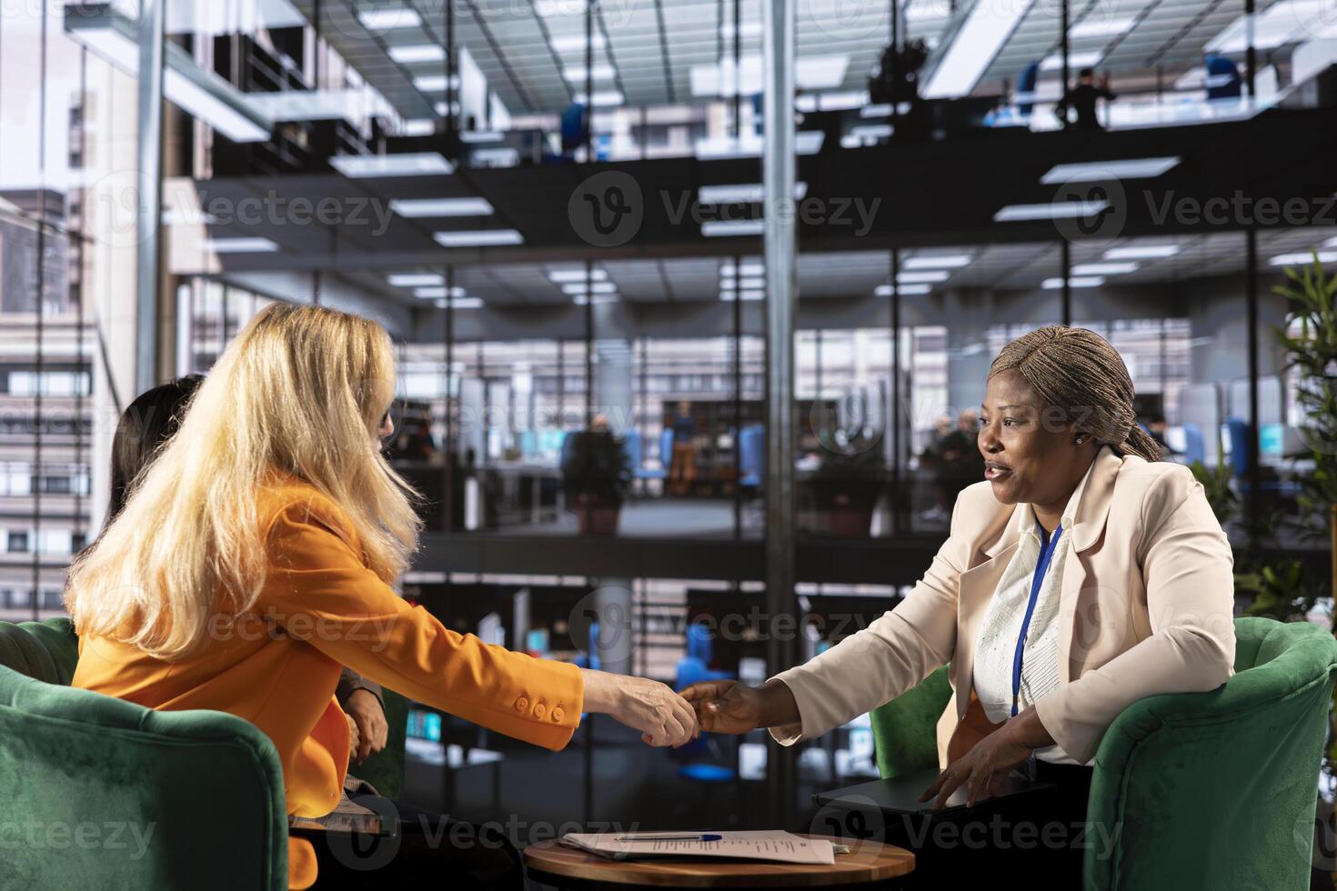 Team of empowered businesswomen in a corporate meeting making a deal, signing a contract that signifies business growth. Female leaders working on legal forms of insurance in the office. photo