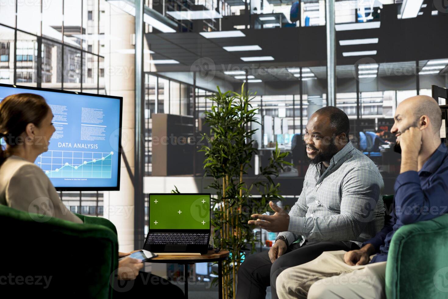 Green screen laptop used by multiethnic team preparing for business meeting, having discussion. Mockup notebook used by multiracial employees doing brainstorming in startup photo