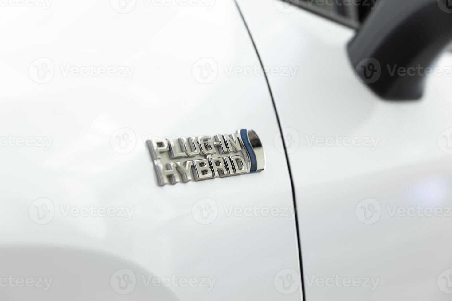 Logo of plug in hybrid electric vehicle using batteries and fuel to power electric motor, producing lower levels of emissions. EV car with rechargeable battery from external power source, close up photo