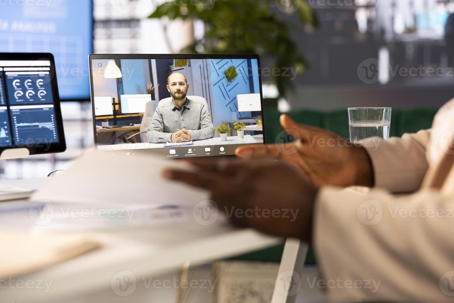 Staff member in modern startup office showing manager progress on customer commissioned project during videocall. Accountant presenting team leader key data statistics after business audit photo
