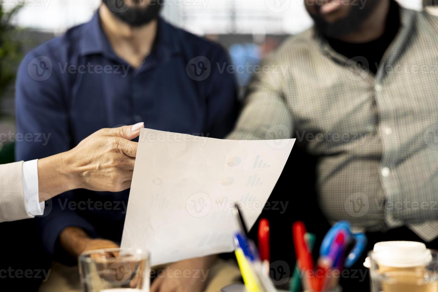 Management executive attends meeting to discuss about new business vision with executive board presenting him business growth ideas. Close up of coworkers pitching investment strategy to director photo