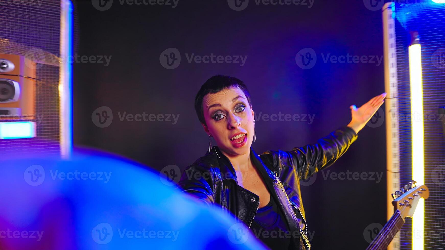 POV of confident iconic performer recording an online vlog for her fans on social media, keeping in touch with her audience. Woman rocker with grunge tough style filming a . photo