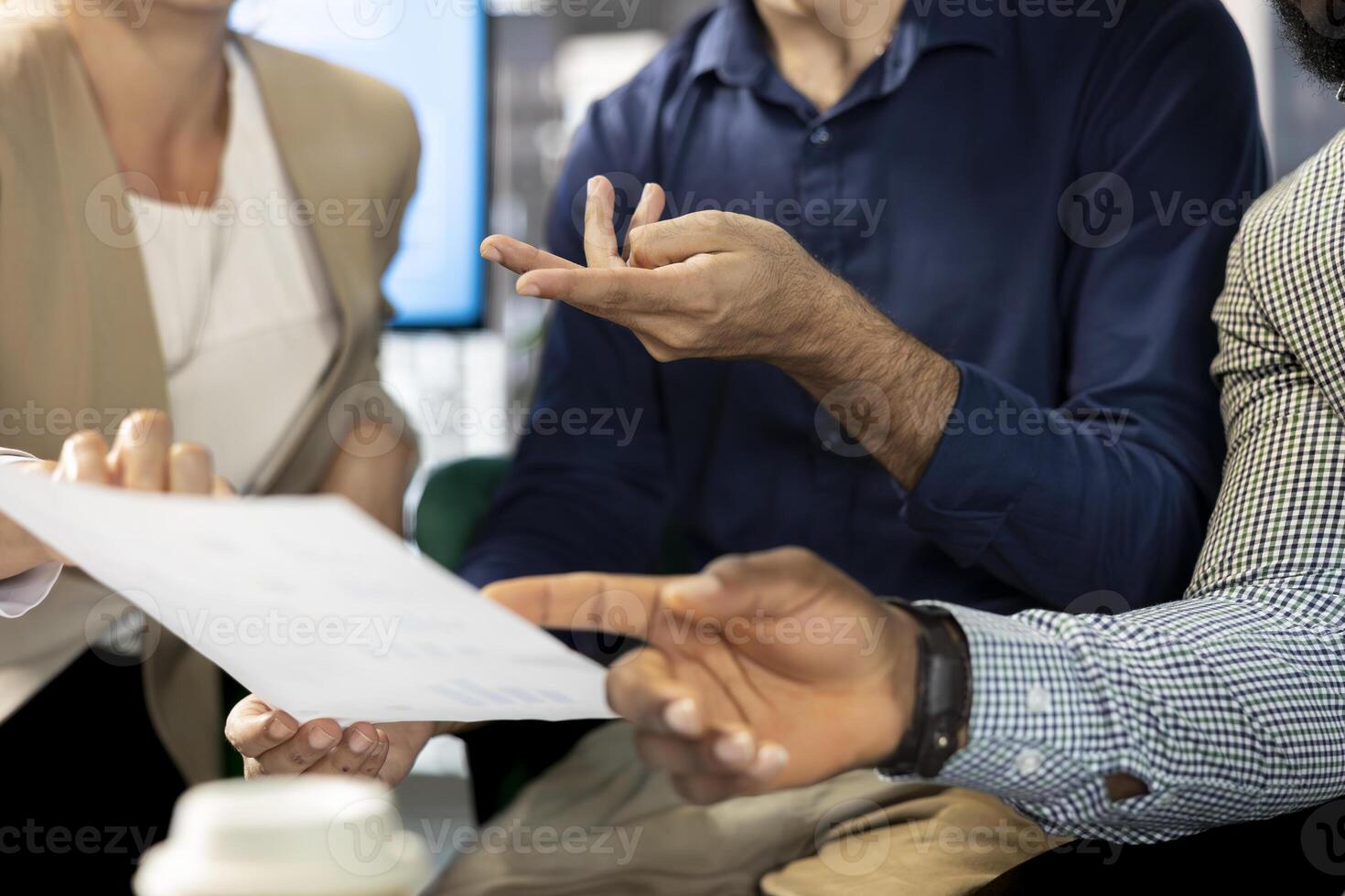 Colleague doing briefing meeting to share new ideas for profit growth, presenting paperwork. Close up of employee in office talking with director, showing progress done on project photo