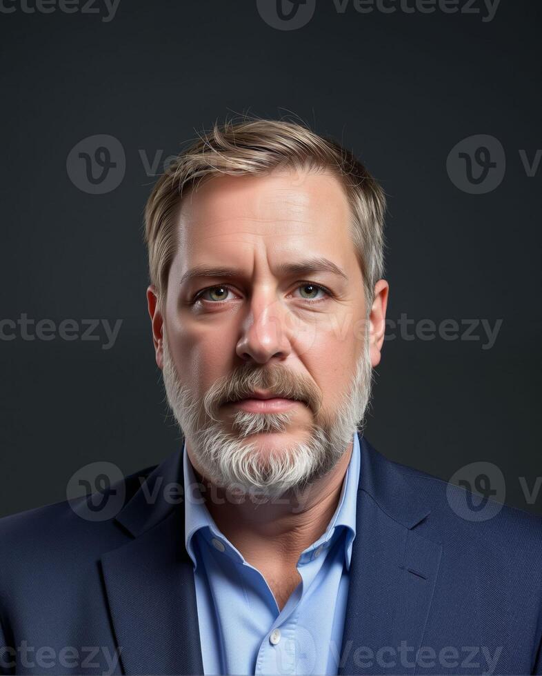 Professional male portrait in a dark setting with serious expression photo