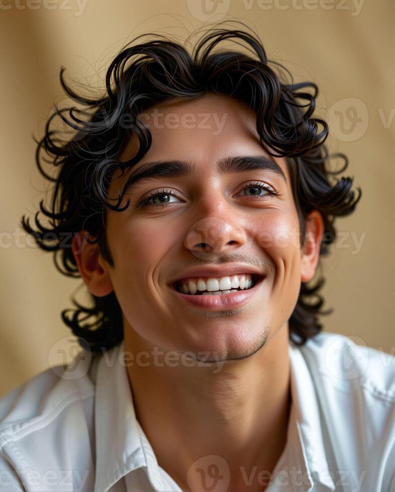 Smiling Young Man with Curly Hair Posing Against a Neutral Background photo