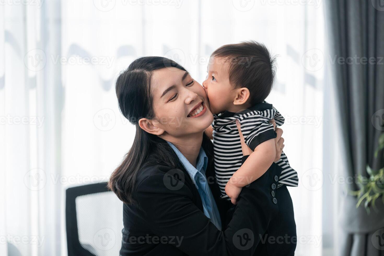 Joyful reunion in a modern office setting between mother and child during the workday photo