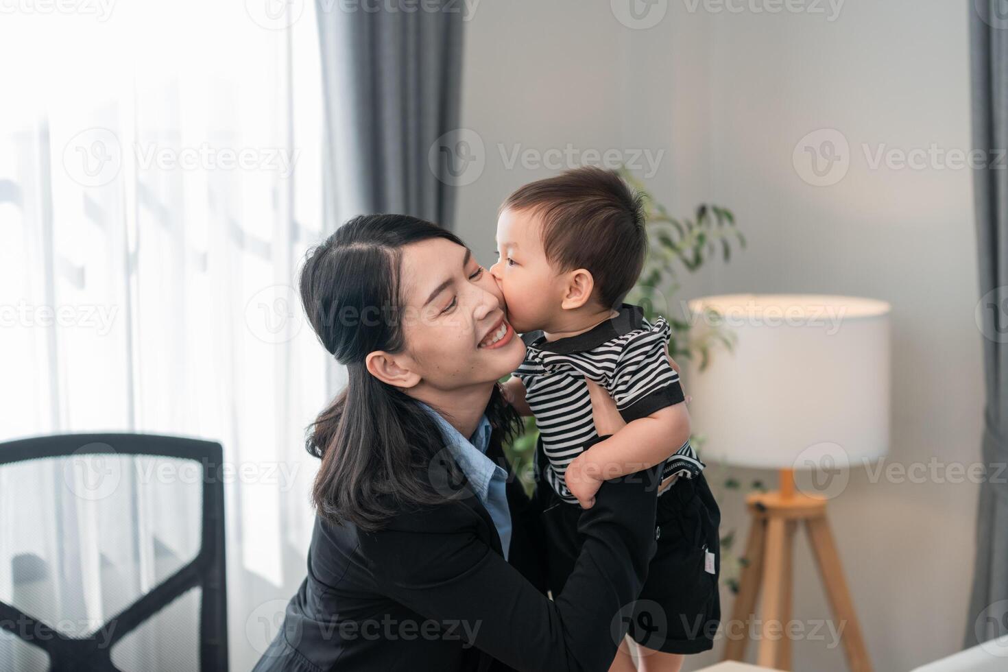 Joyful reunion of mother and child in a bright, modern workspace during a sunny afternoon photo