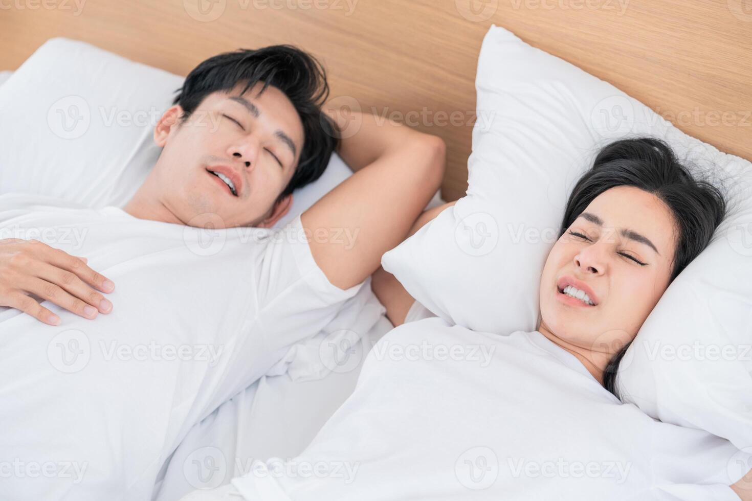 Couple resting peacefully on a bed in a bright and cozy bedroom setting during the morning hours photo