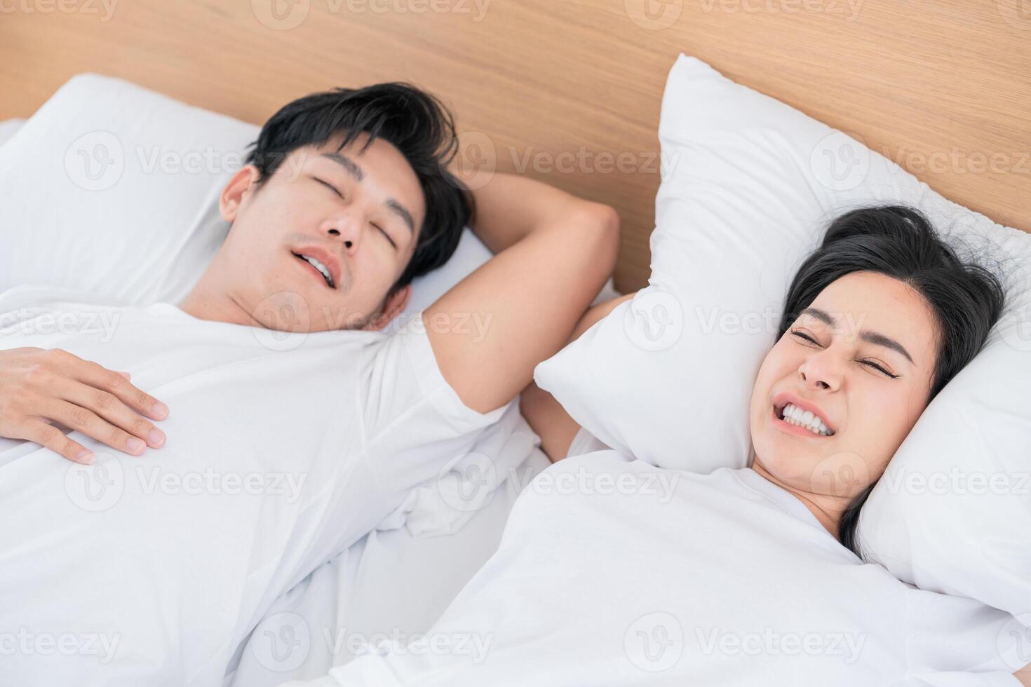 Couple enjoying a peaceful night of sleep in a cozy bedroom with soft bedding and natural light streaming in photo