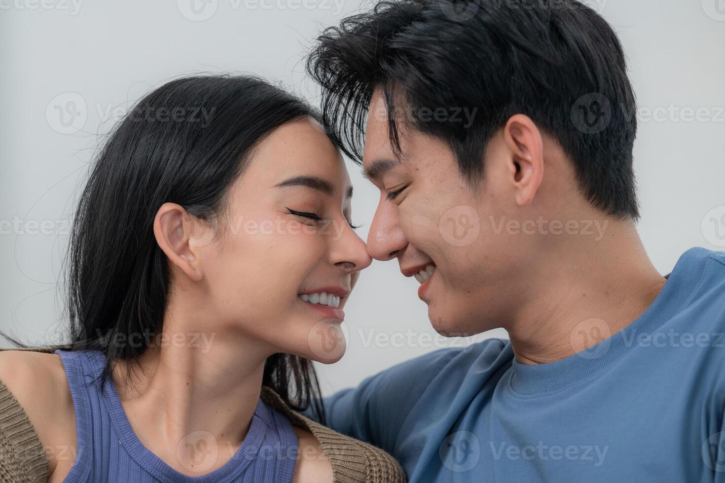 A happy couple sits on their laps, showcasing an ultrasound image with smiles. The warm atmosphere captures their excitement about expecting a baby. photo