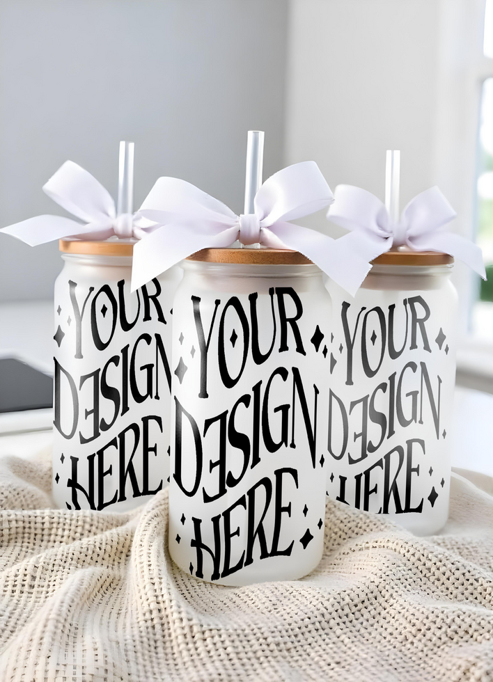 Three mockup frosted glass cups with bamboo lids and white ribbon bows, mockup cups psd