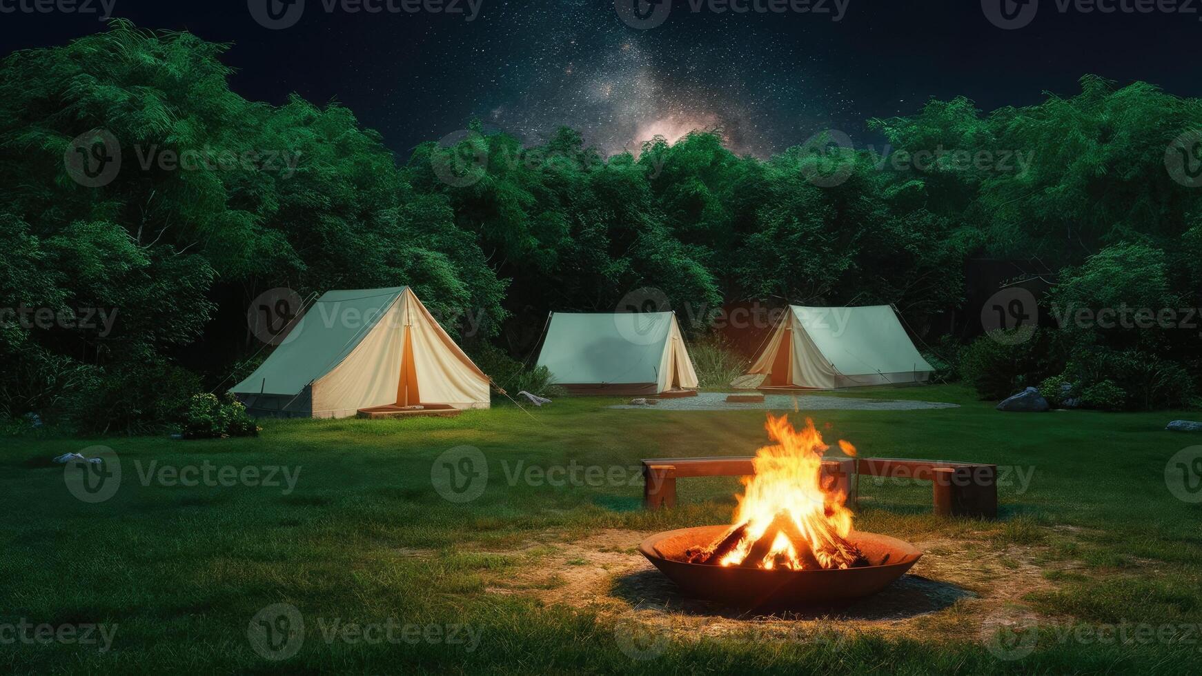 The charming and vibrant night view features a peaceful campsite in the heart of a lush green forest photo