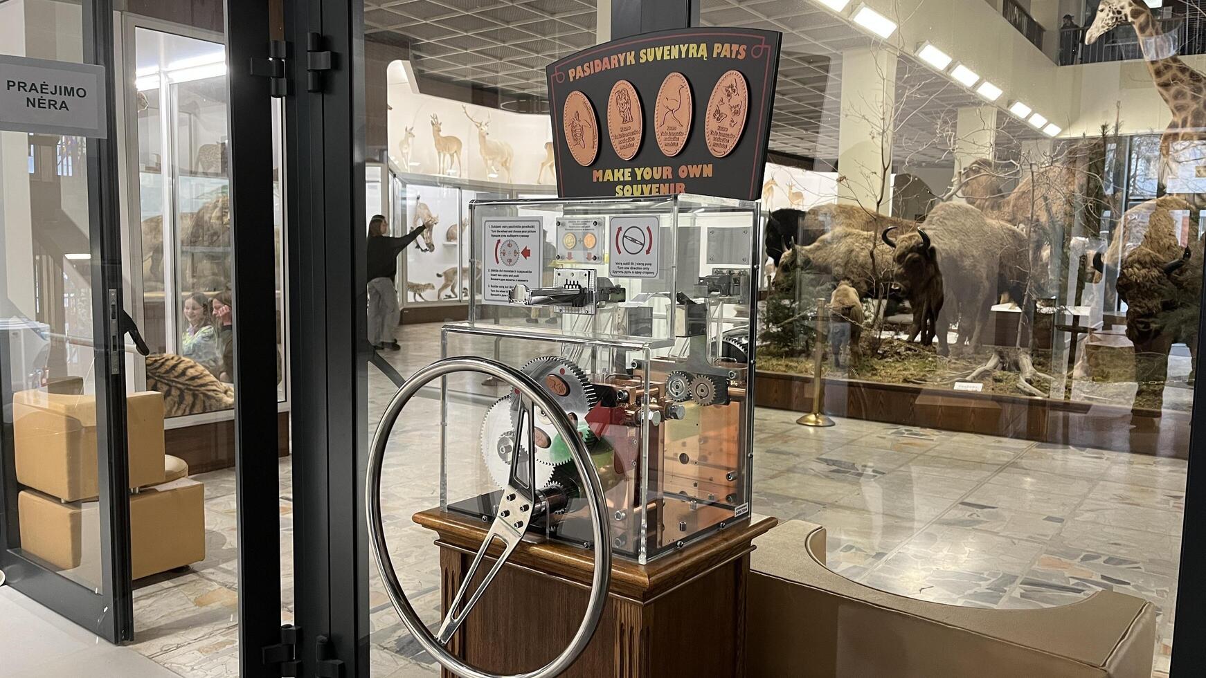 Kaunas, Lithuania. February 16, 2025. A vintage style machine for making your own souvenir coins stands prominently in a museum exhibit in Kaunas Tadas Ivanauskas Museum of Zoology photo