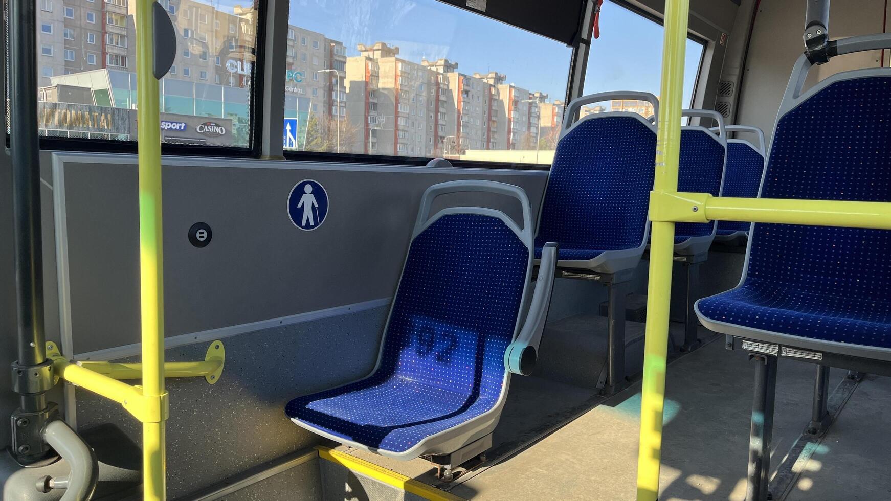 Kaunas, Lithuania. Feb 23, 2025. Interior view of a public bus featuring designated seats, likely for elderly, disabled, or pregnant passengers. Comfortable public transportation for all passengers. photo