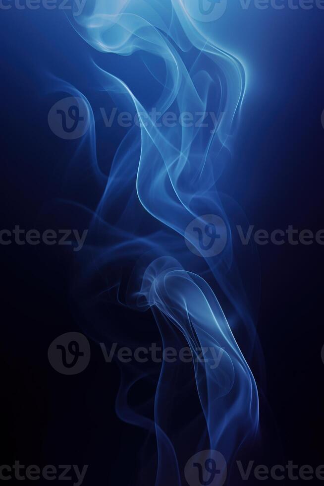 vertical image blue smoke swirling on black background, abstract foggy scene photo