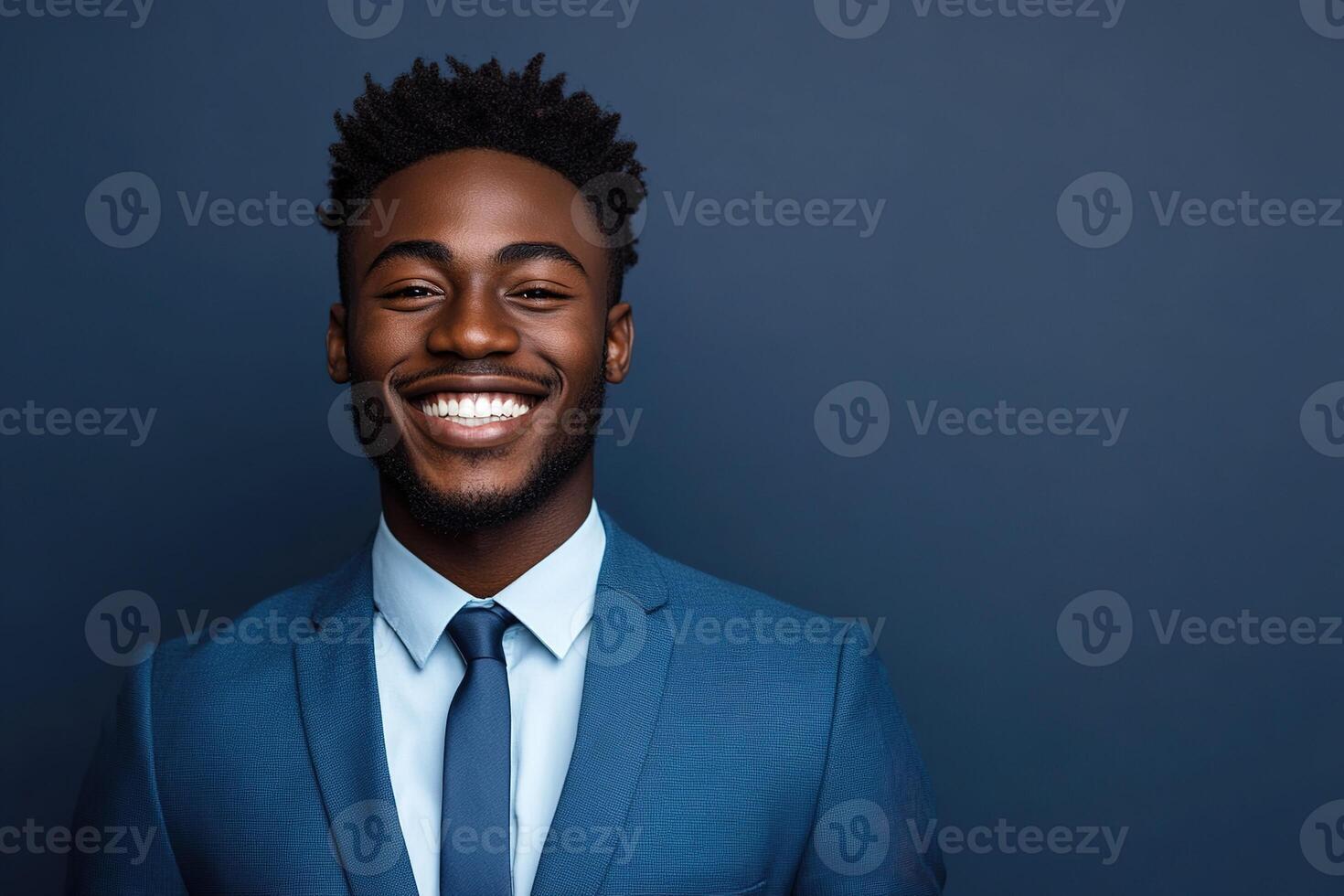 cheerful african american man wearing business suit and necktie on grey background with copy space photo