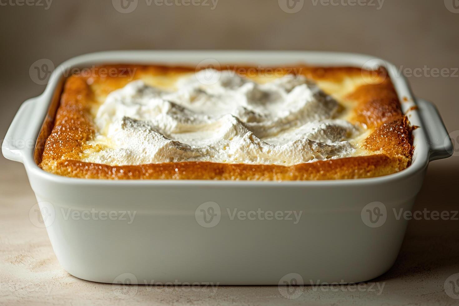 Mexican tres leches cake in a white dish, moist texture glistening under bright lighting, minimal background to focus on the creamy layers and light whipped topping photo