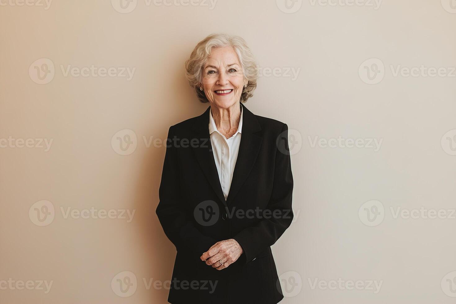 portrait stylish cheerful senior caucasian businesswoman wearing black suit and tie on light beige background photo