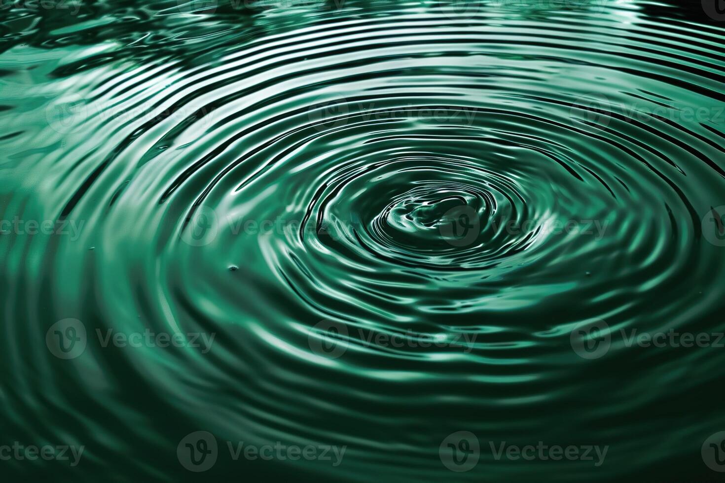abstract calm background ripples spread out around the green clear water photo