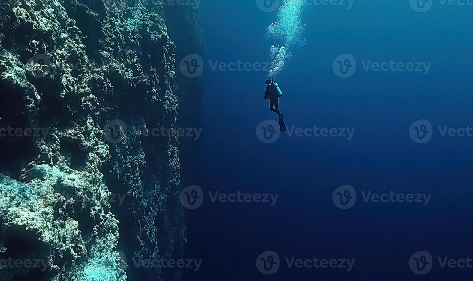 Scuba diving, underwater diver swimming inside Great Blue Hole sinkhole with oxygen tanks and gear. Belize, tourism, copy space photo