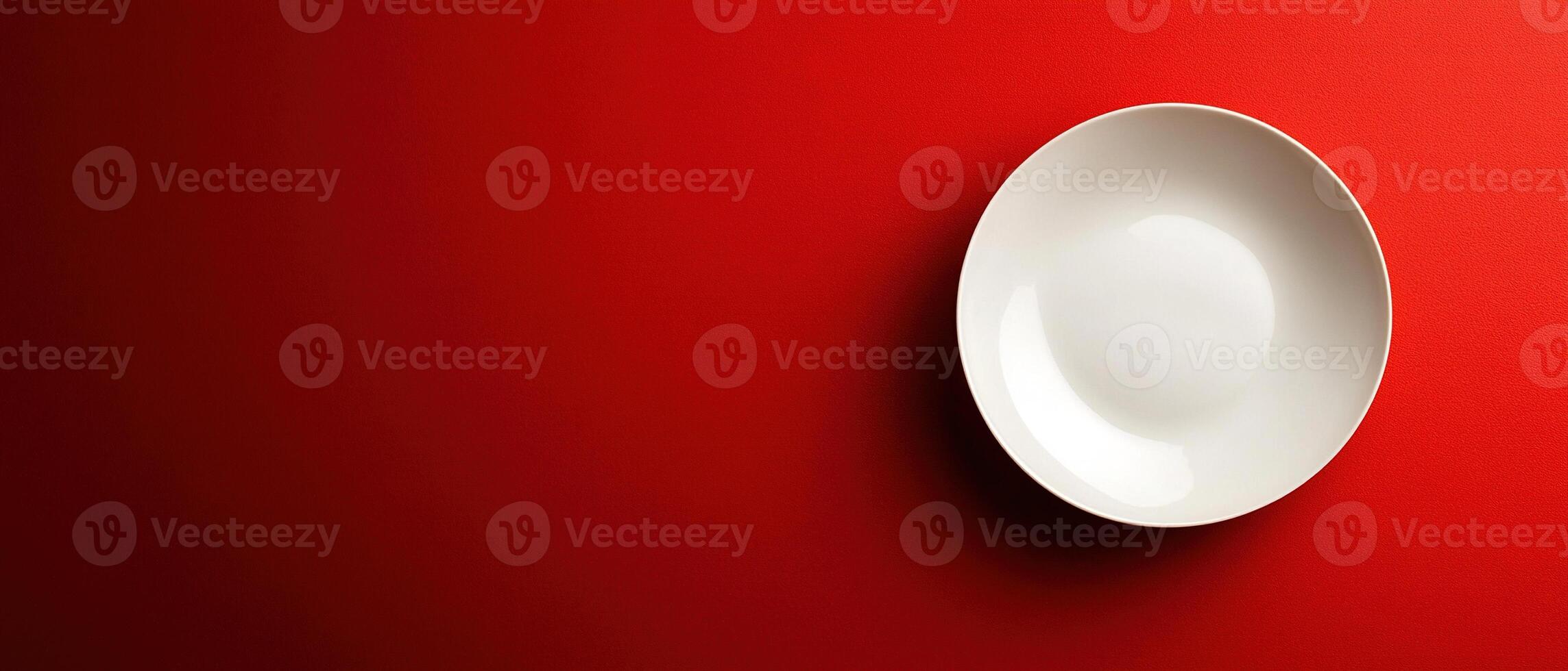 Minimalist White Plate on Bold Red Background with Copy Space photo