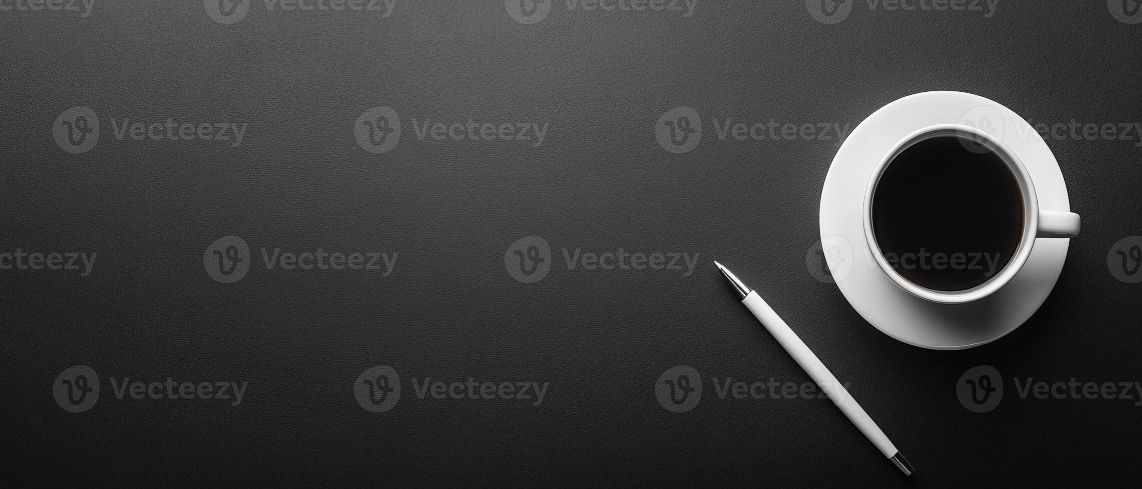 Top View of Elegant Workspace with Black Background White Cup of Coffee and Pen photo