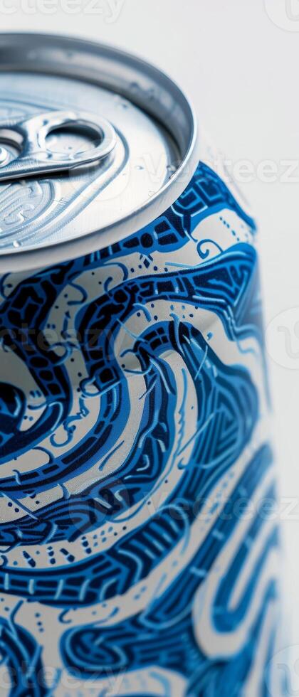 Highlighting a white beer can, this close-up showcases an elaborate blue design that captures the viewer's attention. The can is positioned against a light backdrop for contrast photo