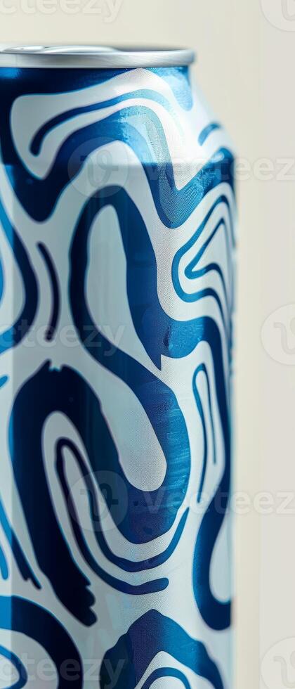 A close-up view of a white beer can featuring a striking blue pattern, emphasizing its unique design against a neutral backdrop that enhances its modern aesthetic photo