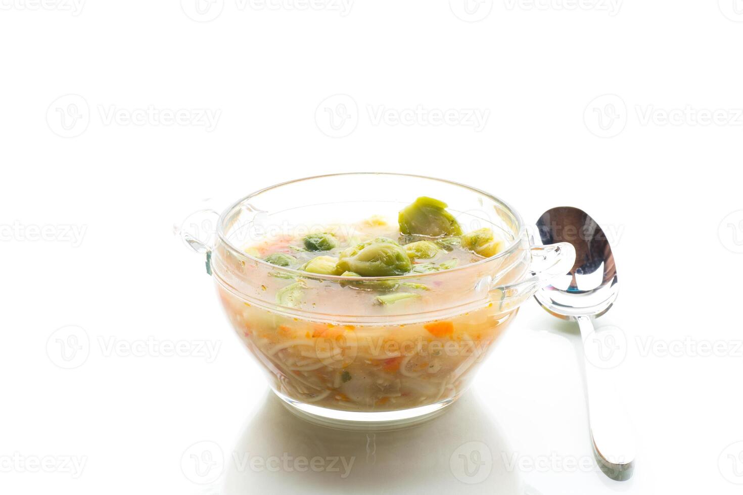 Simple diet lunch.Natural vegetable soup with brussels sprouts, isolated on white background photo