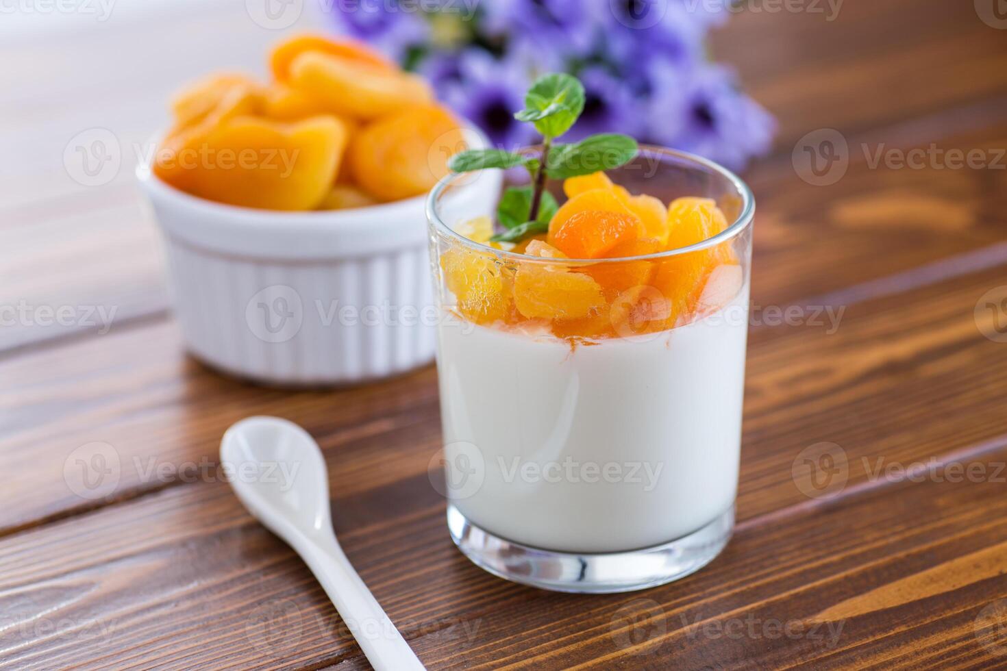 Light breakfast with fruit yogurt and dried apricots photo