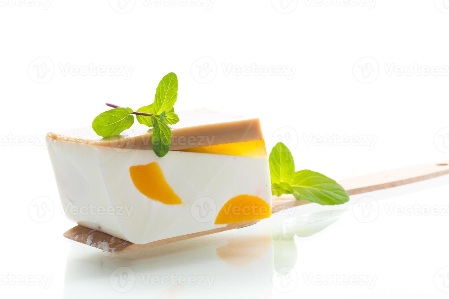 pieces of fruit inside milk fruit jelly on white background photo