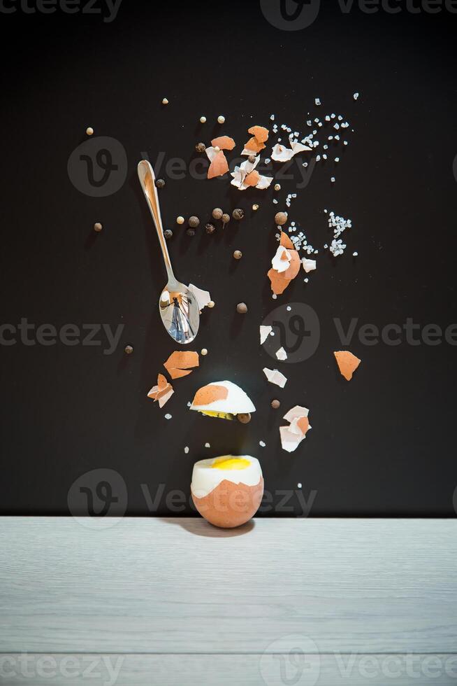 the taste of breakfast. Black background, minimalism and egg in section photo
